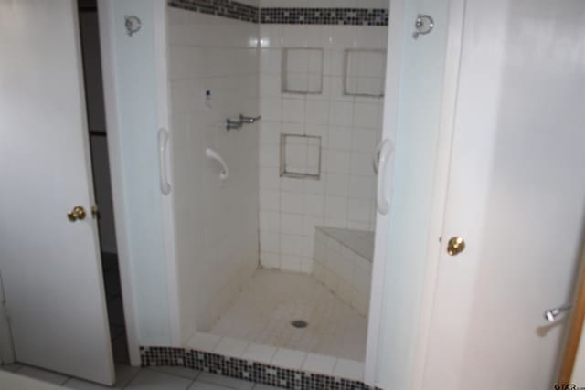 bathroom with tile patterned flooring and a stall shower