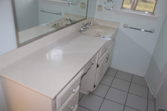 bathroom featuring tile patterned floors, baseboards, and vanity