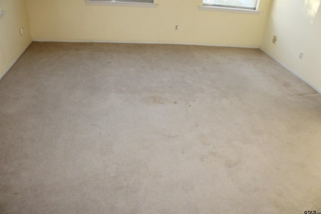empty room featuring light carpet