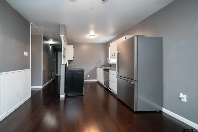 kitchen featuring white cabinets, appliances with stainless steel finishes, sink, and dark hardwood / wood-style flooring