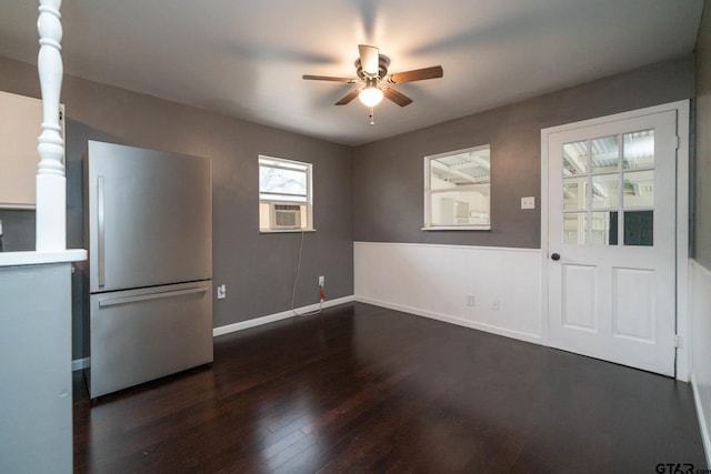 interior space with ceiling fan, cooling unit, and dark hardwood / wood-style floors