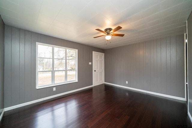 unfurnished room featuring ceiling fan and dark hardwood / wood-style flooring