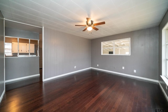 unfurnished room featuring ceiling fan and dark hardwood / wood-style flooring