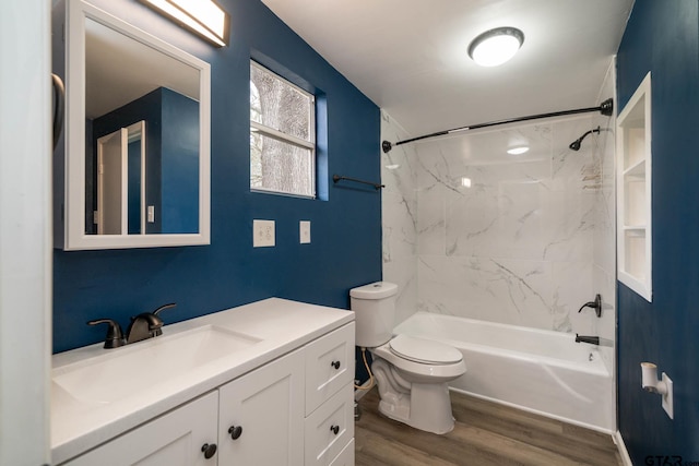 full bathroom with toilet, tiled shower / bath, vanity, and hardwood / wood-style flooring