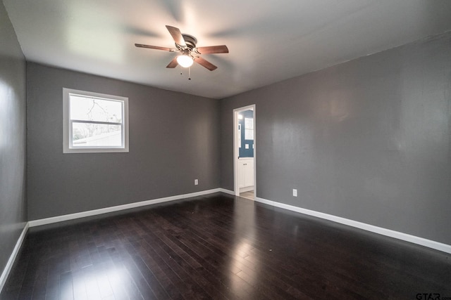 empty room with ceiling fan and dark hardwood / wood-style floors