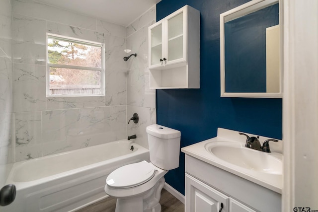 full bathroom featuring hardwood / wood-style floors, toilet, vanity, and tiled shower / bath combo