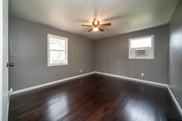 empty room featuring dark wood-type flooring, cooling unit, and ceiling fan