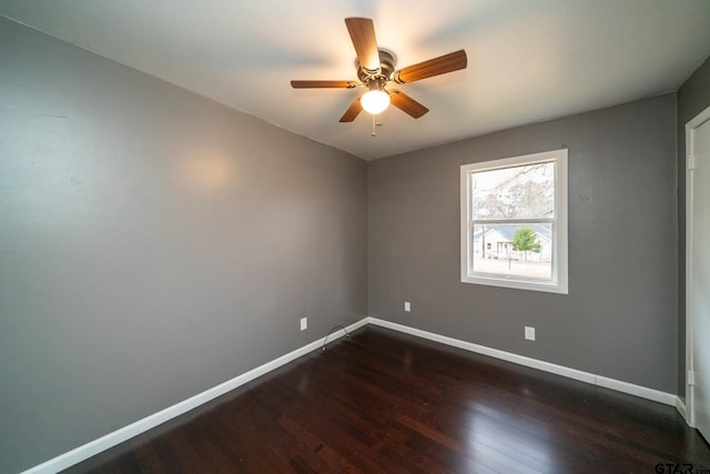 spare room featuring ceiling fan and dark hardwood / wood-style floors