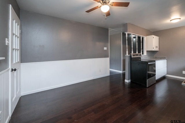 kitchen with stainless steel electric stove, white cabinets, dark hardwood / wood-style flooring, and ceiling fan