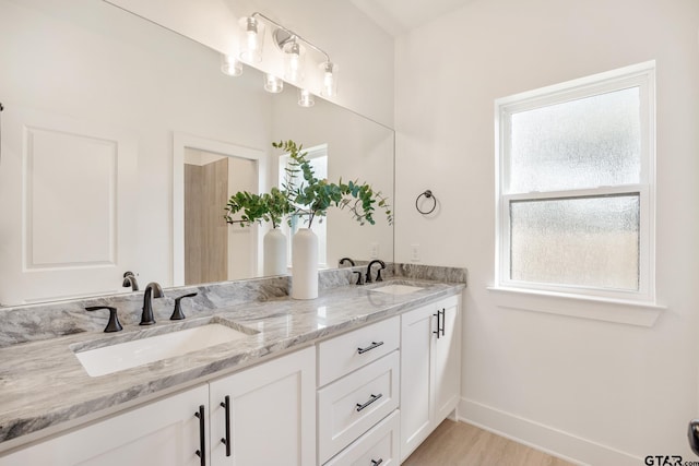 bathroom with vanity and wood-type flooring