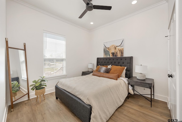 bedroom featuring crown molding, ceiling fan, and light hardwood / wood-style floors