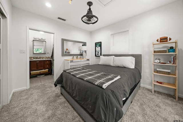 301 W Charnwood St, Tyler, TX 75701 - bedroom with light colored carpet, baseboards, connected bathroom, and attic access