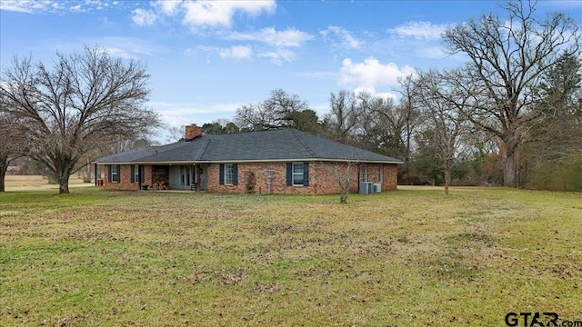 exterior space with a lawn and central air condition unit