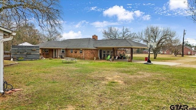 rear view of house featuring a lawn