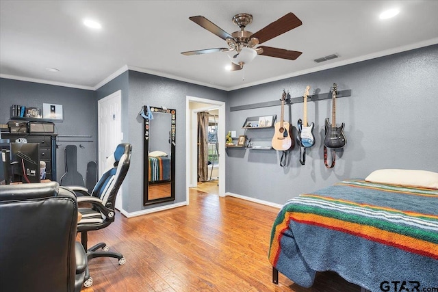 bedroom with crown molding, ceiling fan, and light hardwood / wood-style floors