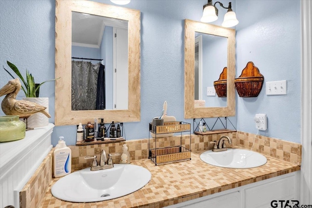 bathroom with ornamental molding, decorative backsplash, and vanity