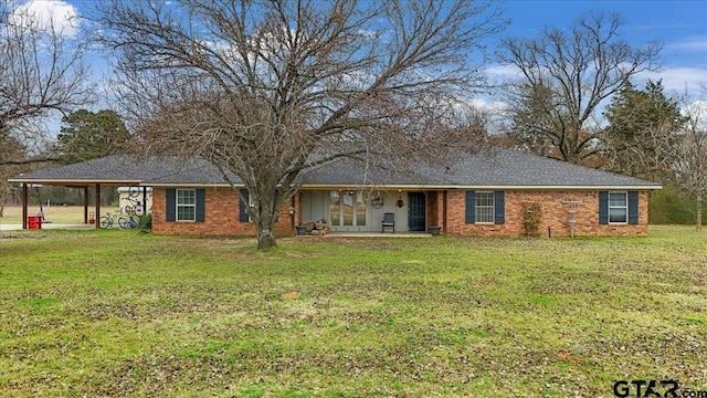 single story home featuring a carport and a front yard