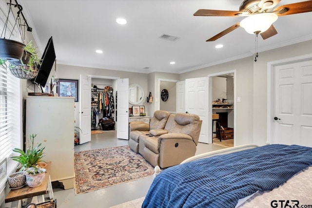 bedroom featuring crown molding, concrete floors, ceiling fan, a walk in closet, and a closet