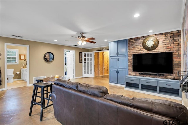 living room with crown molding and ceiling fan