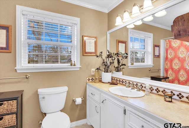 bathroom with vanity, crown molding, toilet, and walk in shower