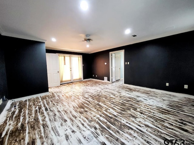 unfurnished living room featuring wood-type flooring and ornamental molding