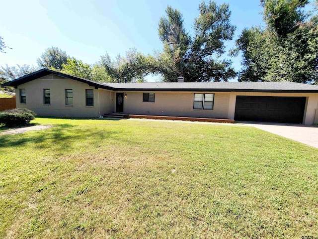 ranch-style home featuring a garage and a front yard