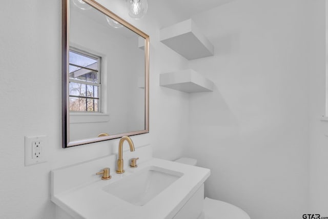 bathroom featuring vanity and toilet