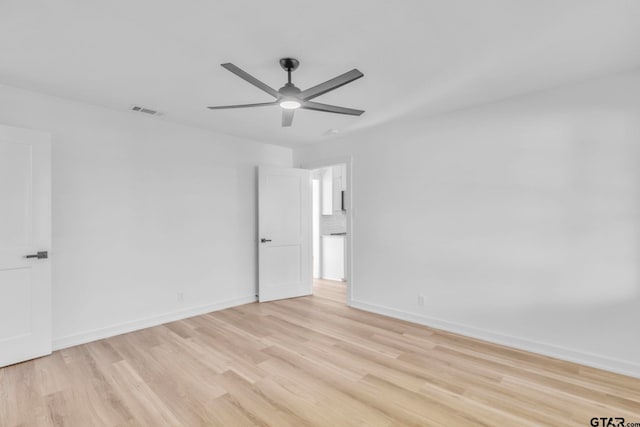 spare room with ceiling fan and light hardwood / wood-style floors