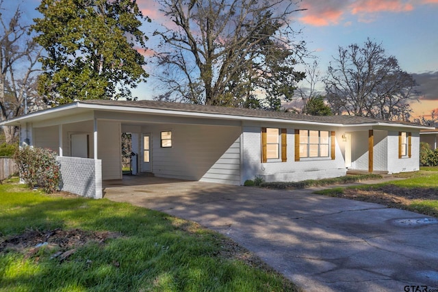 view of front facade with a yard and a carport