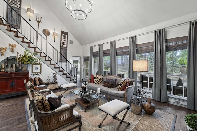 living area with stairs, high vaulted ceiling, a wealth of natural light, and wood finished floors