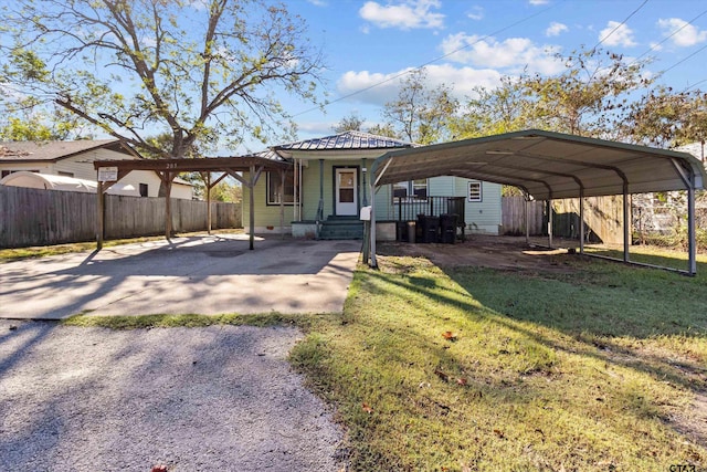 rear view of house with a yard and a carport