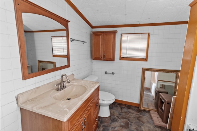 bathroom featuring vaulted ceiling, vanity, toilet, and tile walls