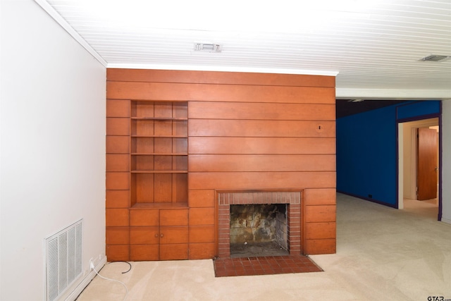 unfurnished living room featuring light carpet and a brick fireplace