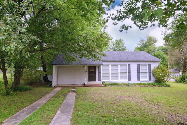 ranch-style home featuring a garage and a front lawn