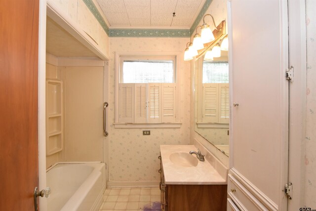 bathroom with a washtub and vanity