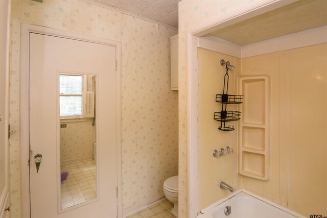 bathroom featuring tile patterned floors, a textured ceiling, toilet, and shower / bath combination