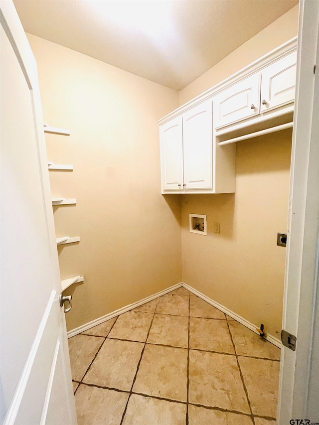 laundry area with light tile patterned flooring, washer hookup, baseboards, cabinet space, and electric dryer hookup