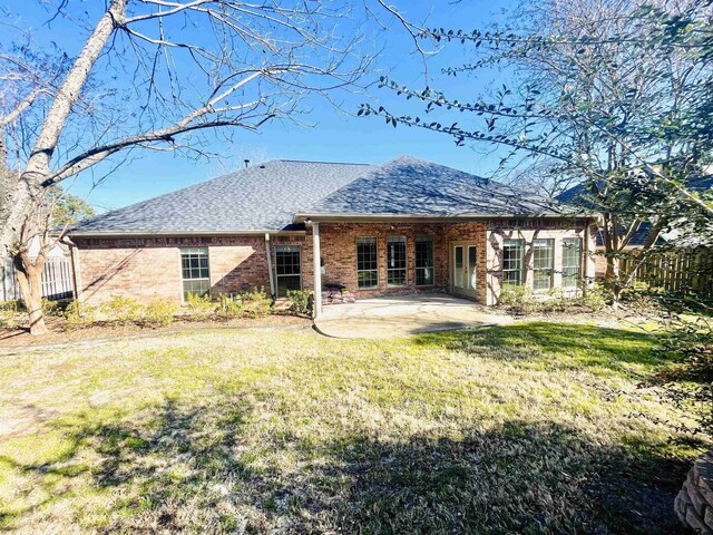 5603 Thomas Nelson Dr, Tyler, TX 75707 - back of property featuring a patio area, a shingled roof, and brick siding