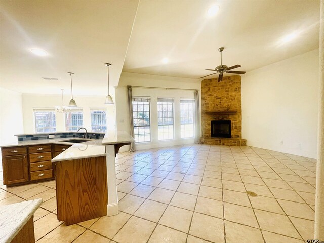 5603 Thomas Nelson Dr, Tyler, TX 75707 - kitchen featuring open floor plan, ceiling fan, light tile patterned floors, a fireplace, and recessed lighting