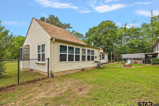 view of property exterior featuring fence and a lawn