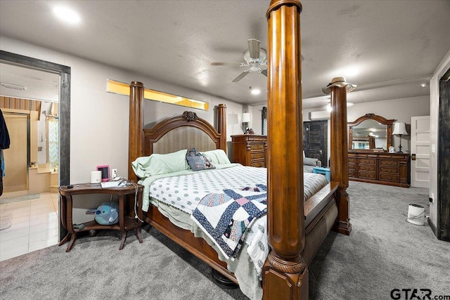 carpeted bedroom with a ceiling fan and connected bathroom