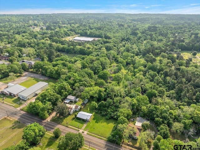 birds eye view of property featuring a wooded view