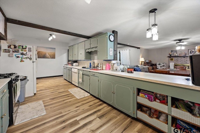 kitchen featuring green cabinets, light countertops, black gas range oven, dishwasher, and a sink