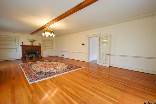 510 E Longview St, Arp, TX 75750 - living area featuring wood finished floors, beam ceiling, built in shelves, a fireplace, and a chandelier