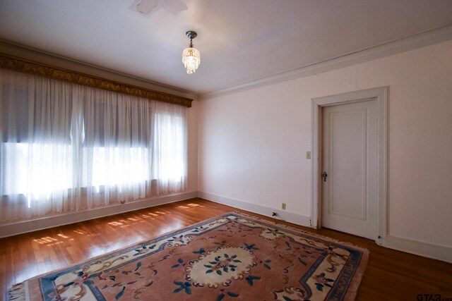510 E Longview St, Arp, TX 75750 - spare room featuring baseboards and wood finished floors