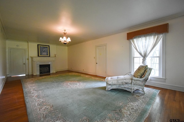 510 E Longview St, Arp, TX 75750 - unfurnished living room with a chandelier, ornamental molding, baseboards, hardwood / wood-style floors, and a fireplace