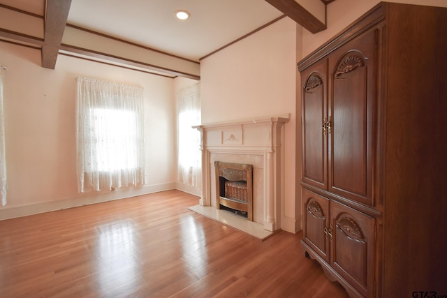510 E Longview St, Arp, TX 75750 - unfurnished living room with light wood-style flooring, a high end fireplace, baseboards, and beam ceiling