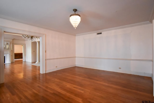 510 E Longview St, Arp, TX 75750 - empty room featuring a chandelier, wood finished floors, ornamental molding, and baseboards