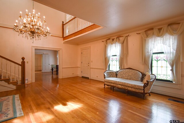 510 E Longview St, Arp, TX 75750 - unfurnished room with stairs, wood finished floors, a chandelier, crown molding, and baseboards