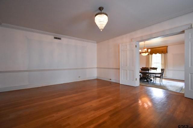 510 E Longview St, Arp, TX 75750 - unfurnished room featuring a chandelier, wood finished floors, baseboards, and ornamental molding